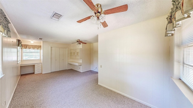 10335 Nolan Dr, Tyler, TX 75709 - carpeted empty room with a ceiling fan, a textured ceiling, and baseboards