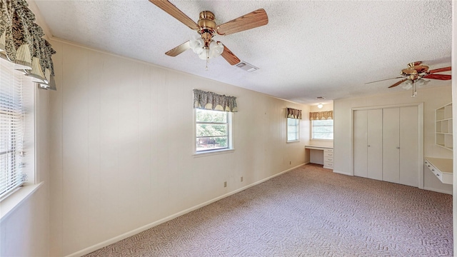 10335 Nolan Dr, Tyler, TX 75709 - unfurnished bedroom with a textured ceiling, carpet floors, ceiling fan, baseboards, and a closet