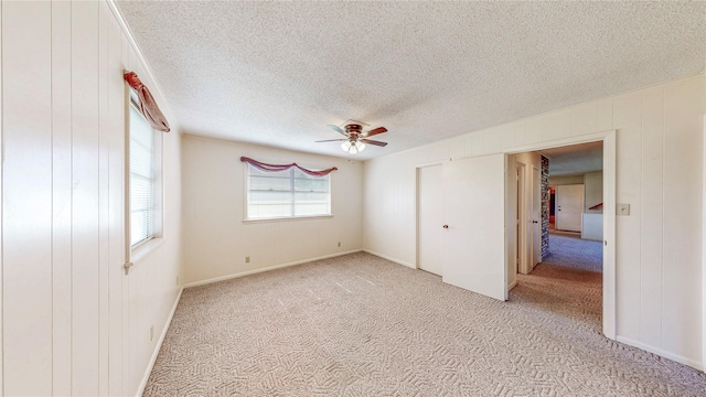 10335 Nolan Dr, Tyler, TX 75709 - unfurnished bedroom featuring light colored carpet, a textured ceiling, and a ceiling fan