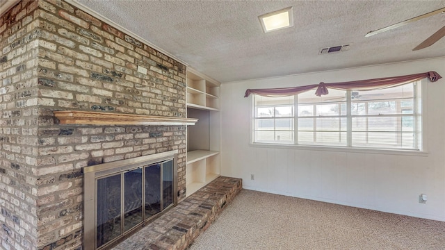 10335 Nolan Dr, Tyler, TX 75709 - unfurnished living room with a textured ceiling, carpet floors, healthy amount of natural light, a fireplace, and crown molding