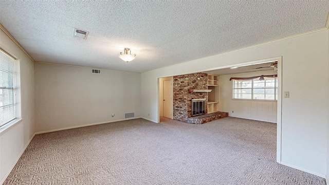 10335 Nolan Dr, Tyler, TX 75709 - unfurnished living room featuring a fireplace, carpet, and a textured ceiling