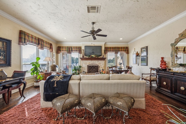 2590 King Arthur Blvd, Lewisville, TX 75056 - living room with plenty of natural light, a ceiling fan, dark wood-style floors, a fireplace, and a textured ceiling