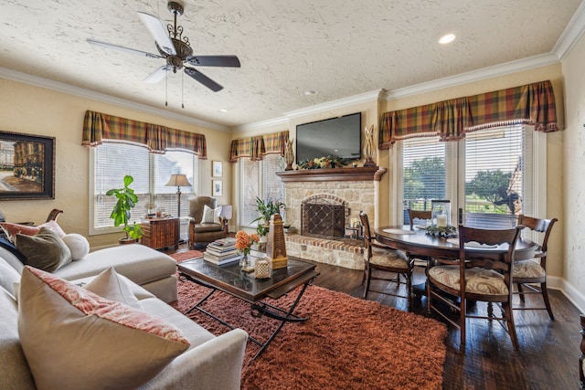 2590 King Arthur Blvd, Lewisville, TX 75056 - living area with a ceiling fan, dark wood-style flooring, a fireplace, baseboards, and crown molding