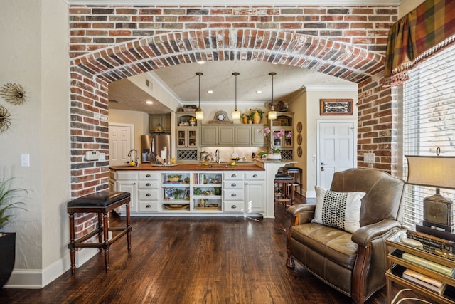 2590 King Arthur Blvd, Lewisville, TX 75056 - indoor wet bar with stainless steel fridge, baseboards, ornamental molding, dark wood finished floors, and decorative backsplash