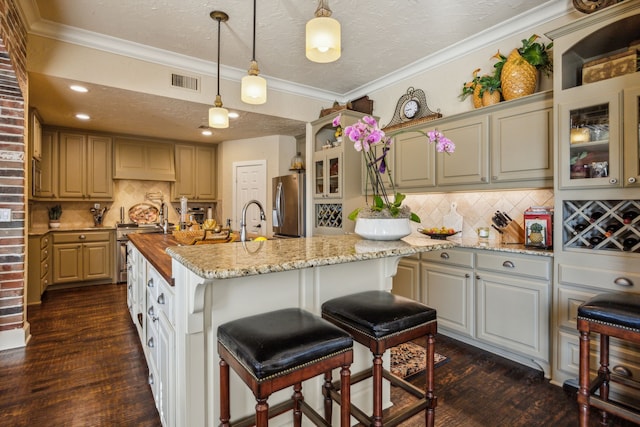 2590 King Arthur Blvd, Lewisville, TX 75056 - kitchen featuring appliances with stainless steel finishes, dark wood-type flooring, tasteful backsplash, glass insert cabinets, and ornamental molding