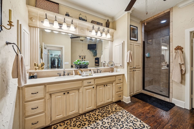 2590 King Arthur Blvd, Lewisville, TX 75056 - full bathroom featuring double vanity, a shower stall, wood finished floors, ornamental molding, and a ceiling fan