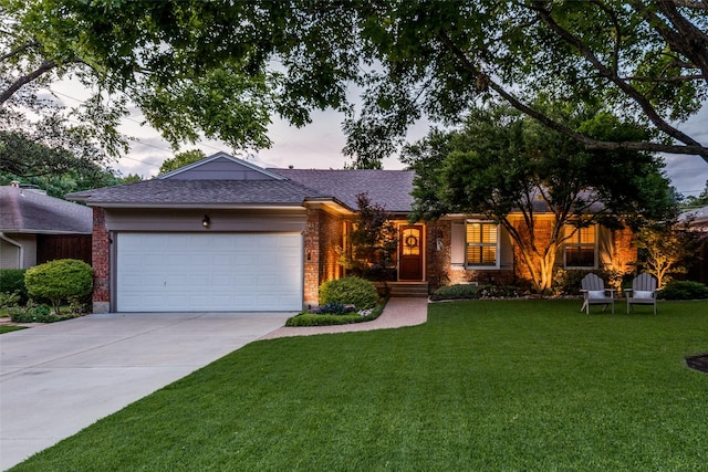 704 Winchester Dr, Richardson, TX 75080 - single story home featuring a garage, concrete driveway, a front yard, brick siding, and a shingled roof