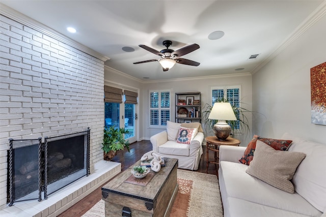704 Winchester Dr, Richardson, TX 75080 - living room with ornamental molding, wood finished floors, ceiling fan, and a fireplace