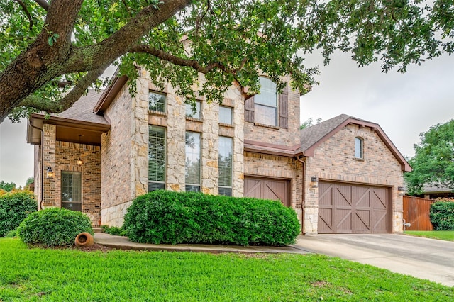 201 Barkley Dr, Hickory Creek, TX 75065 - view of front of house with a garage, driveway, brick siding, roof with shingles, and a front yard