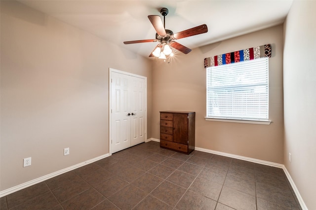 201 Barkley Dr, Hickory Creek, TX 75065 - spare room with a ceiling fan, dark tile patterned floors, and baseboards