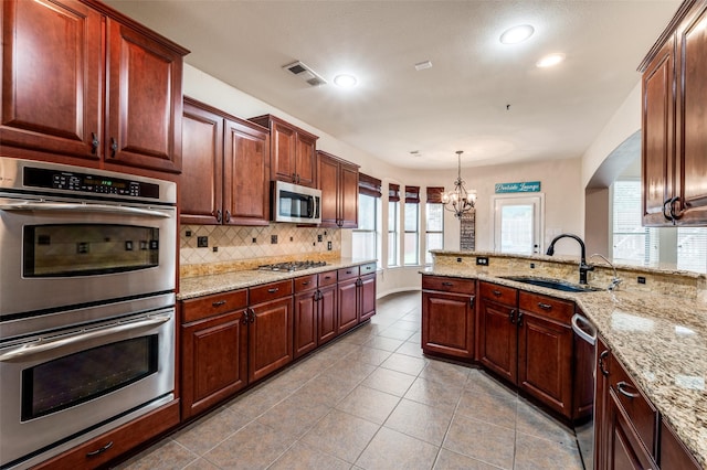 201 Barkley Dr, Hickory Creek, TX 75065 - kitchen featuring stainless steel appliances, a sink, tasteful backsplash, a chandelier, and recessed lighting