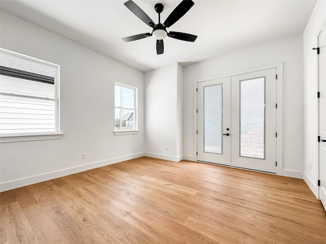 2419 Merlin St, Dallas, TX 75215 - spare room featuring french doors, light wood finished floors, and baseboards
