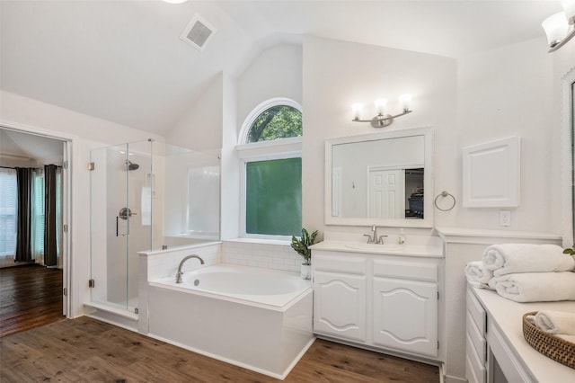 2145 Tartan Trl, Highland Village, TX 75077 - full bathroom featuring a stall shower, vanity, wood finished floors, a garden tub, and high vaulted ceiling