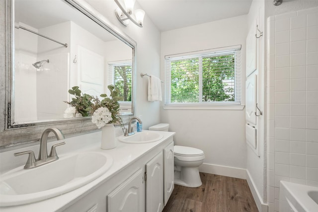 2145 Tartan Trl, Highland Village, TX 75077 - bathroom featuring double vanity, wood finished floors, toilet, shower / bath combination, and baseboards