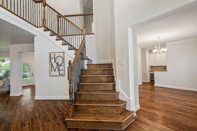 2145 Tartan Trl, Highland Village, TX 75077 - staircase featuring wood finished floors, baseboards, a chandelier, and a towering ceiling