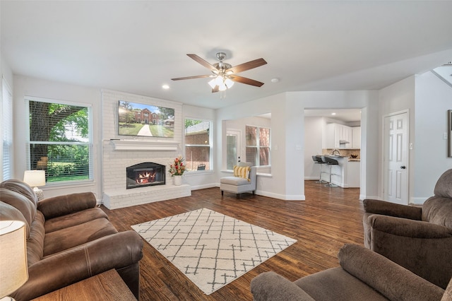 2145 Tartan Trl, Highland Village, TX 75077 - living area with a fireplace, ceiling fan, dark wood-style flooring, baseboards, and recessed lighting