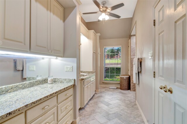 900 N Dove Rd, Grapevine, TX 76051 - full bath featuring vanity, ceiling fan, baseboards, lofted ceiling, and stone finish flooring