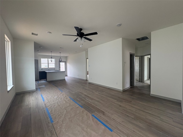 4033 Rimfire Rd, Waco, TX 76705 - unfurnished living room with ceiling fan, wood finished floors, and baseboards