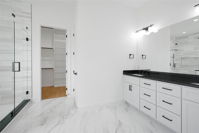 101 Crepe Myrtle, Corsicana, TX 75109 - bathroom with a stall shower, double vanity, a walk in closet, marble look tiles, and baseboards