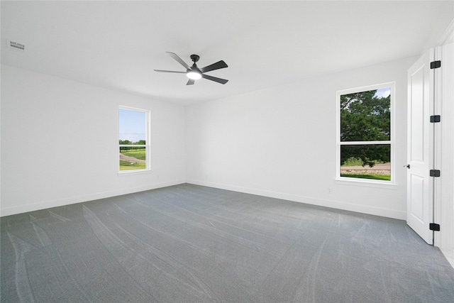 101 Crepe Myrtle, Corsicana, TX 75109 - spare room with dark colored carpet, a ceiling fan, and baseboards