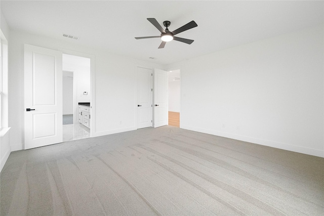 101 Crepe Myrtle, Corsicana, TX 75109 - unfurnished bedroom with carpet flooring, baseboards, ensuite bath, and a ceiling fan