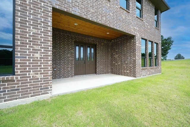 101 Crepe Myrtle, Corsicana, TX 75109 - view of exterior entry featuring brick siding and a lawn