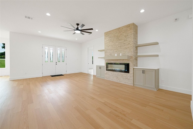 101 Crepe Myrtle, Corsicana, TX 75109 - unfurnished living room with ceiling fan, light wood-style floors, baseboards, recessed lighting, and a stone fireplace