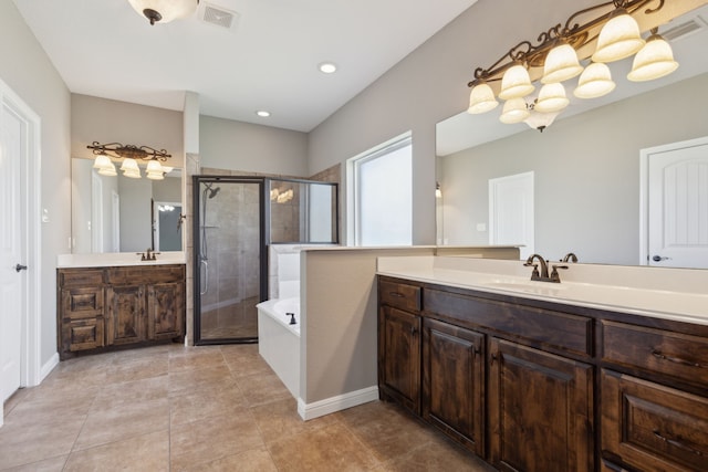 3213 Lakeway Dr, Weatherford, TX 76087 - full bath featuring a shower stall, two vanities, a garden tub, tile patterned flooring, and recessed lighting