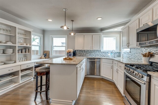 2800 Amherst Ave, University Park, TX 75225 - kitchen featuring stainless steel appliances, open shelves, a peninsula, white cabinetry, and crown molding