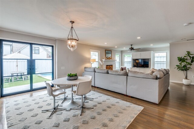 2800 Amherst Ave, University Park, TX 75225 - living area with crown molding, dark wood-style floors, a fireplace, recessed lighting, and french doors
