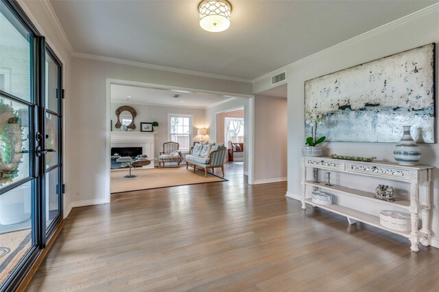 2800 Amherst Ave, University Park, TX 75225 - living room featuring wood finished floors, baseboards, crown molding, and a fireplace
