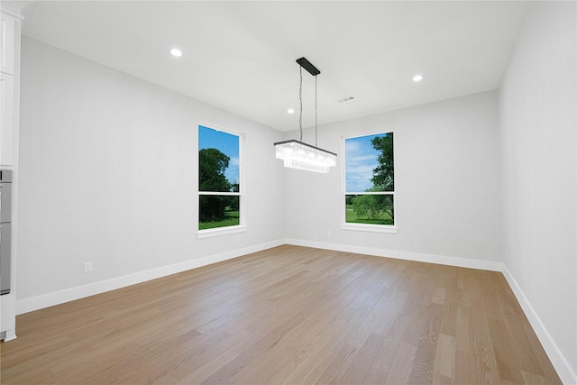 321 El Barco, Corsicana, TX 75109 - unfurnished room with light wood-style floors, recessed lighting, baseboards, and a chandelier