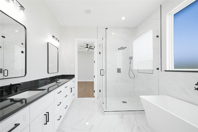 321 El Barco, Corsicana, TX 75109 - bathroom featuring a marble finish shower, a freestanding tub, double vanity, marble look tiles, and ceiling fan