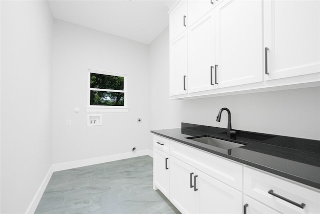 321 El Barco, Corsicana, TX 75109 - washroom featuring cabinet space, baseboards, washer hookup, and electric dryer hookup
