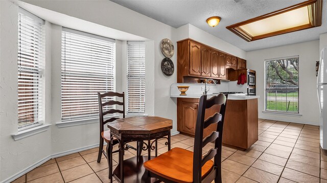 103 Shannon Dr, Allen, TX 75002 - kitchen featuring a sink, black appliances, light tile patterned floors, open shelves, and light countertops