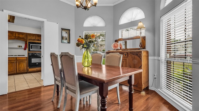 103 Shannon Dr, Allen, TX 75002 - dining room featuring a chandelier, ornamental molding, wood finished floors, and a high ceiling