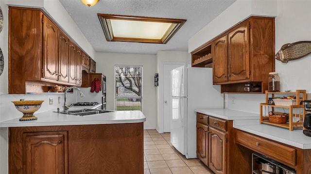 103 Shannon Dr, Allen, TX 75002 - kitchen with freestanding refrigerator, open shelves, light countertops, light tile patterned floors, and a textured ceiling