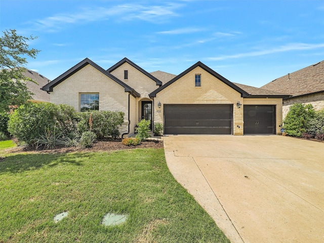 9713 Excursion Dr, Little Elm, TX 75068 - french country inspired facade with an attached garage, concrete driveway, a front lawn, and brick siding