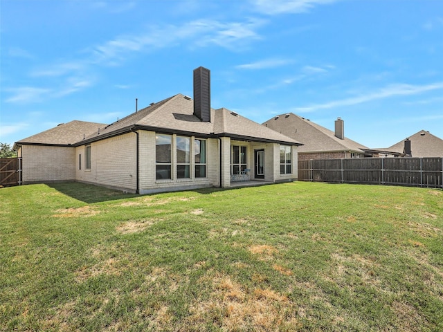 9713 Excursion Dr, Little Elm, TX 75068 - back of property featuring a chimney, brick siding, and a shingled roof