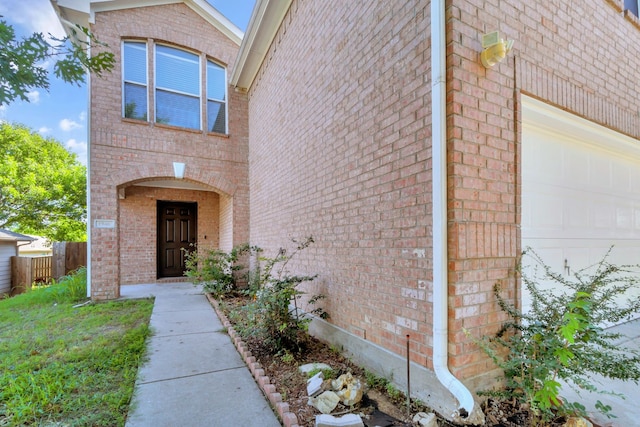 1946 Courtside Dr, Dallas, TX 75051 - doorway to property with brick siding and an attached garage