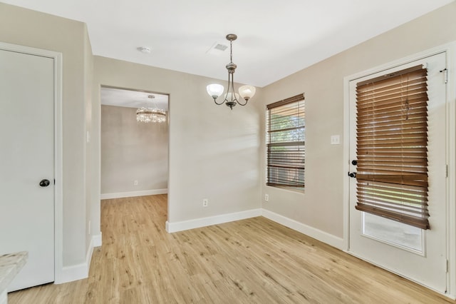 1946 Courtside Dr, Dallas, TX 75051 - unfurnished dining area featuring a chandelier, light wood-type flooring, and baseboards