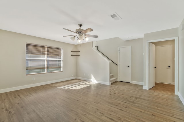 1946 Courtside Dr, Dallas, TX 75051 - unfurnished living room featuring ceiling fan, light wood-style floors, stairs, and baseboards