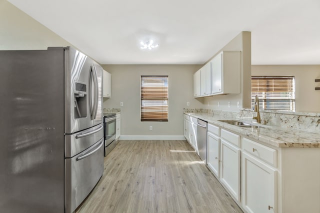 1946 Courtside Dr, Dallas, TX 75051 - kitchen with stainless steel appliances, a sink, healthy amount of natural light, and light wood-style floors