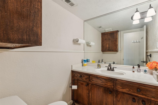 745 Buckner Blvd, Dallas, TX 75218 - half bath with toilet, vanity, and a textured wall