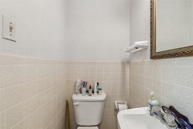 745 Buckner Blvd, Dallas, TX 75218 - bathroom with toilet, tile walls, and wainscoting