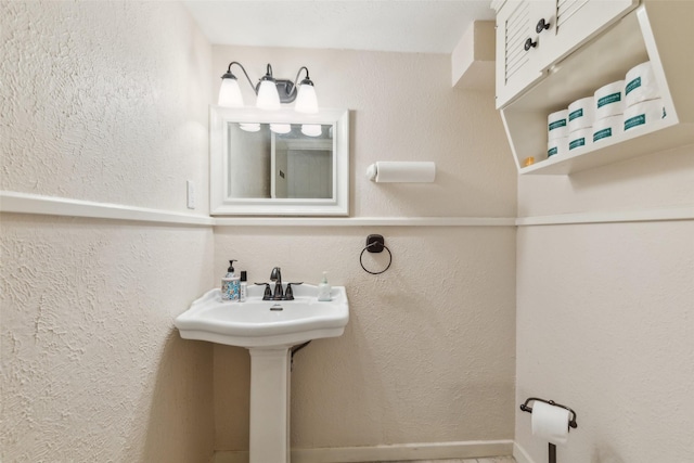 745 Buckner Blvd, Dallas, TX 75218 - bathroom with a textured wall and a sink