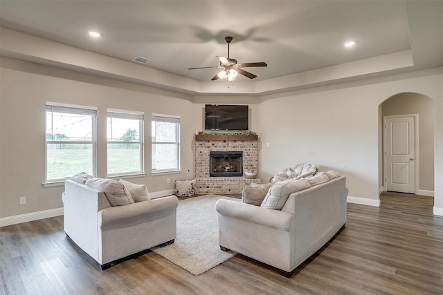 9405 Wildcat Rdg, Godley, TX 76044 - living area with a raised ceiling, arched walkways, a ceiling fan, baseboards, and wood finished floors