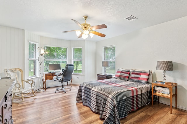 2227 Fm 2815 S, Bonham, TX 75418 - bedroom with wood finished floors, ceiling fan, baseboards, a desk, and a textured ceiling