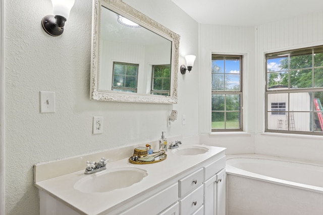 2227 Fm 2815 S, Bonham, TX 75418 - full bath featuring double vanity, a garden tub, and a textured wall