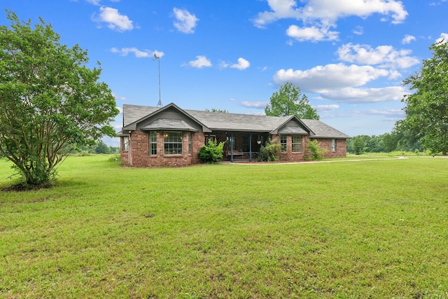 2227 Fm 2815 S, Bonham, TX 75418 - ranch-style home with a front yard, brick siding, and a sunroom